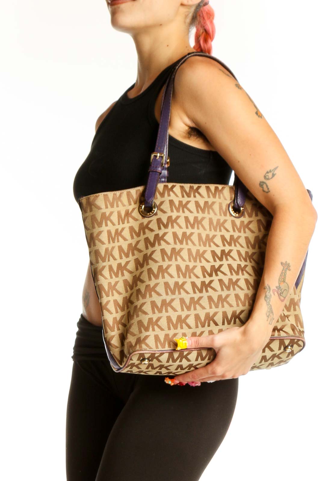 Front view of Michael Kors beige monogram tote bag with purple straps