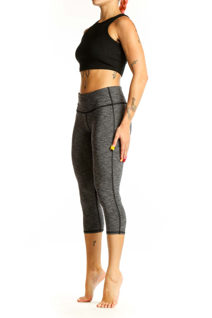 Front view of gray heathered Athleta capri leggings on model