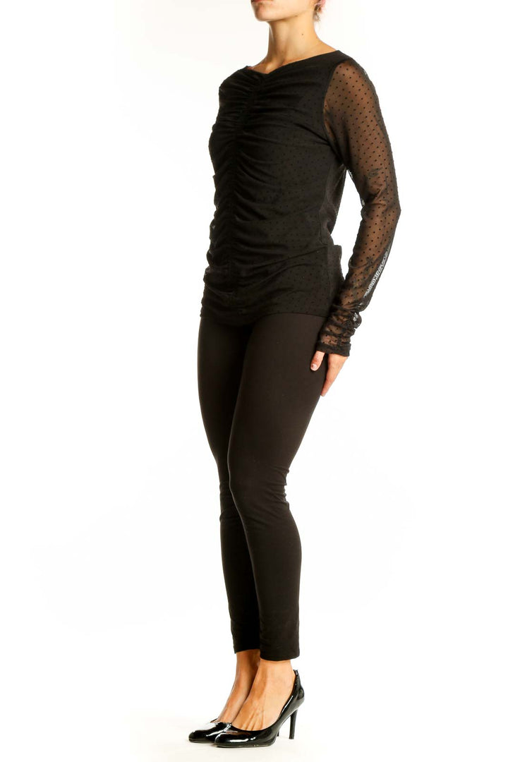 Front view of black ruched top with sheer polka dot sleeves by LAUNDRY by SHELLI SEGAL