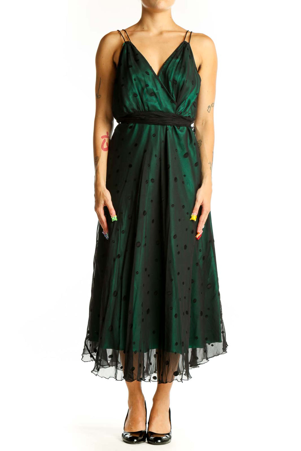 Front view of emerald green polka dot midi dress with wrap-style bodice and black waistband