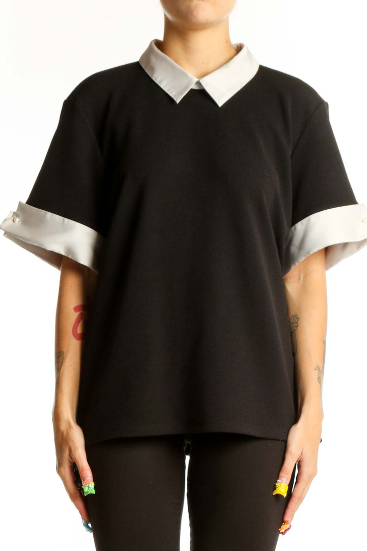 Front view of Karl Lagerfeld Paris black blouse with white collar and cuffs