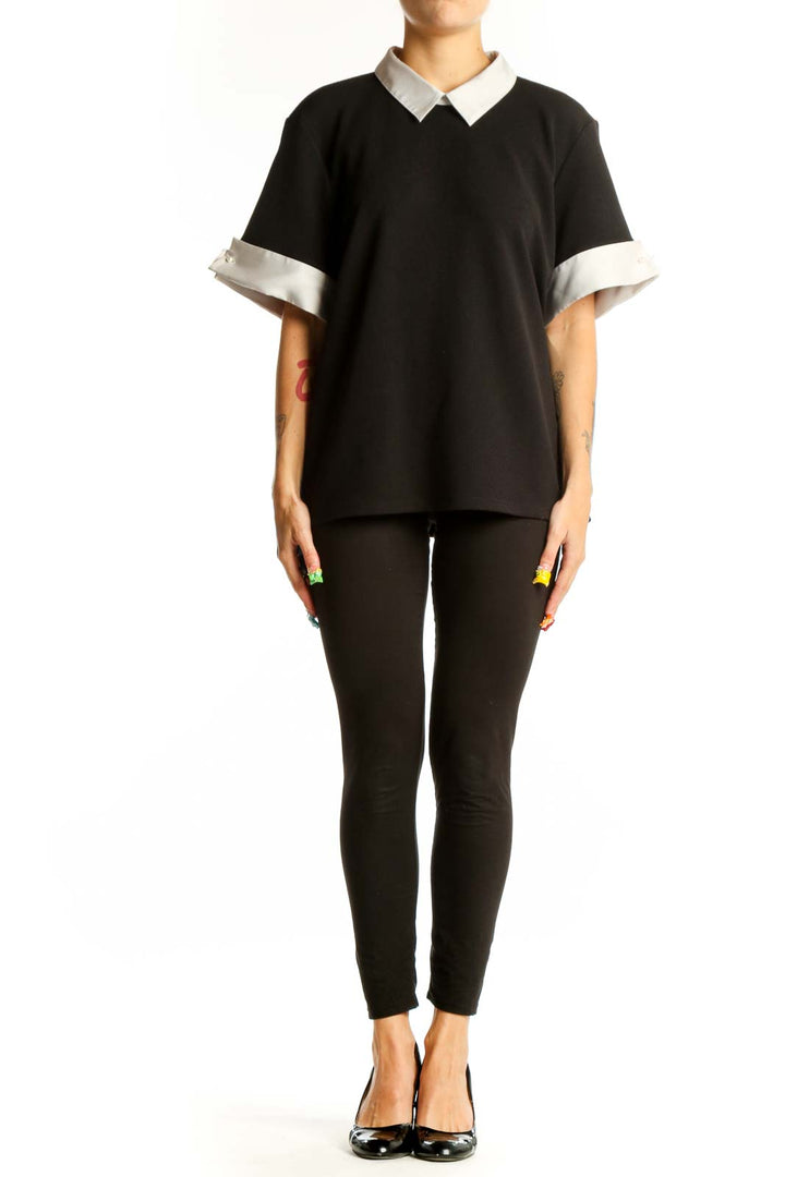 Front view of Karl Lagerfeld Paris black blouse with white collar and cuffs
