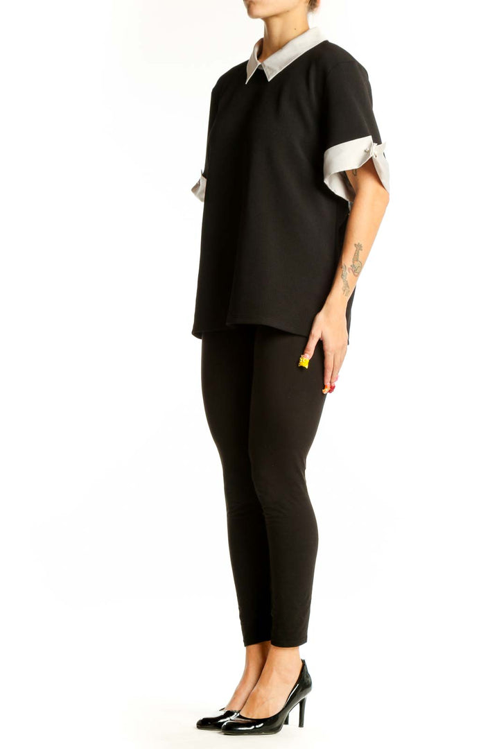 Front view of Karl Lagerfeld Paris black blouse with white collar and cuffs