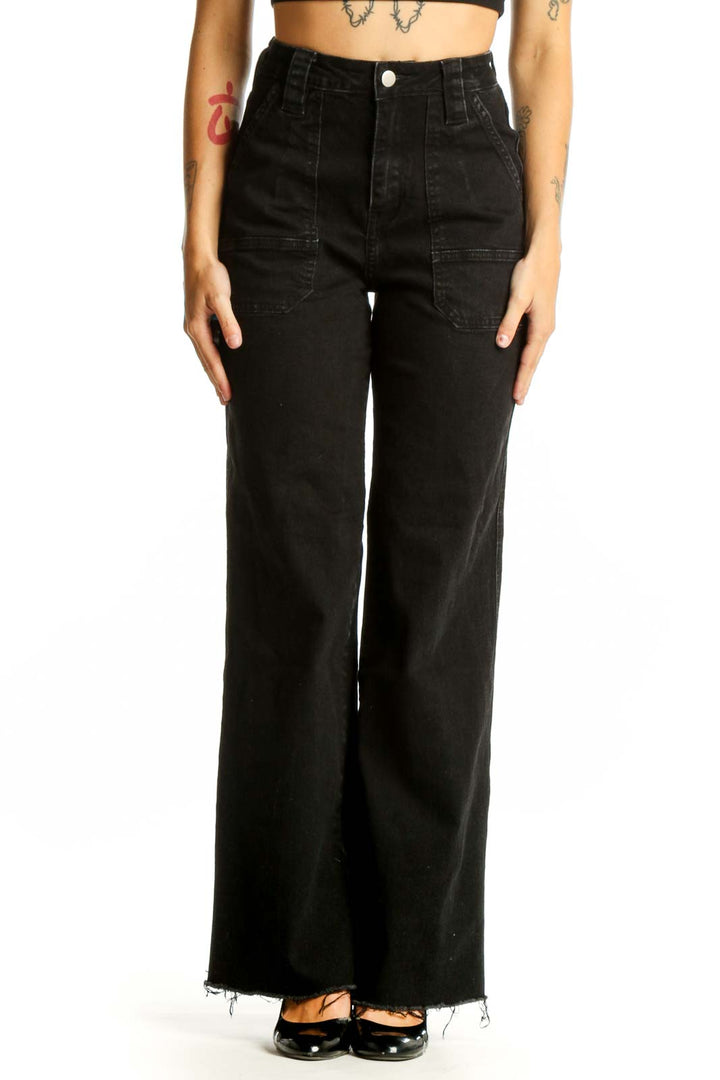 Front view of black wide-leg denim jeans with patch pockets