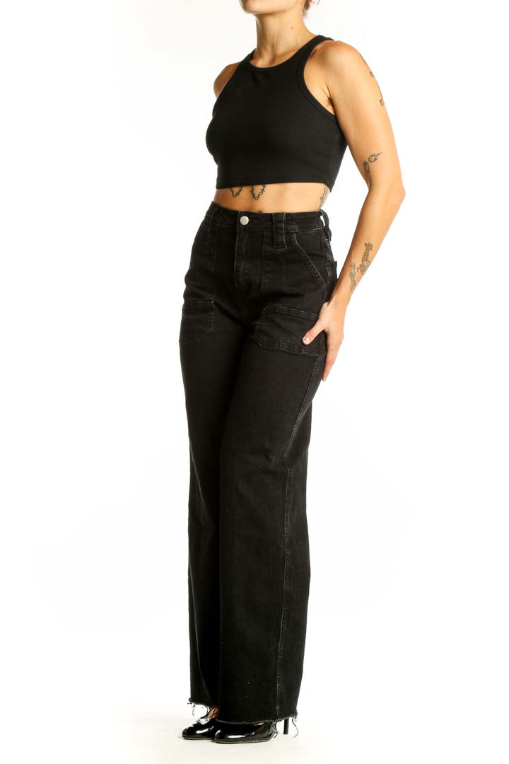 Front view of black wide-leg denim jeans with patch pockets