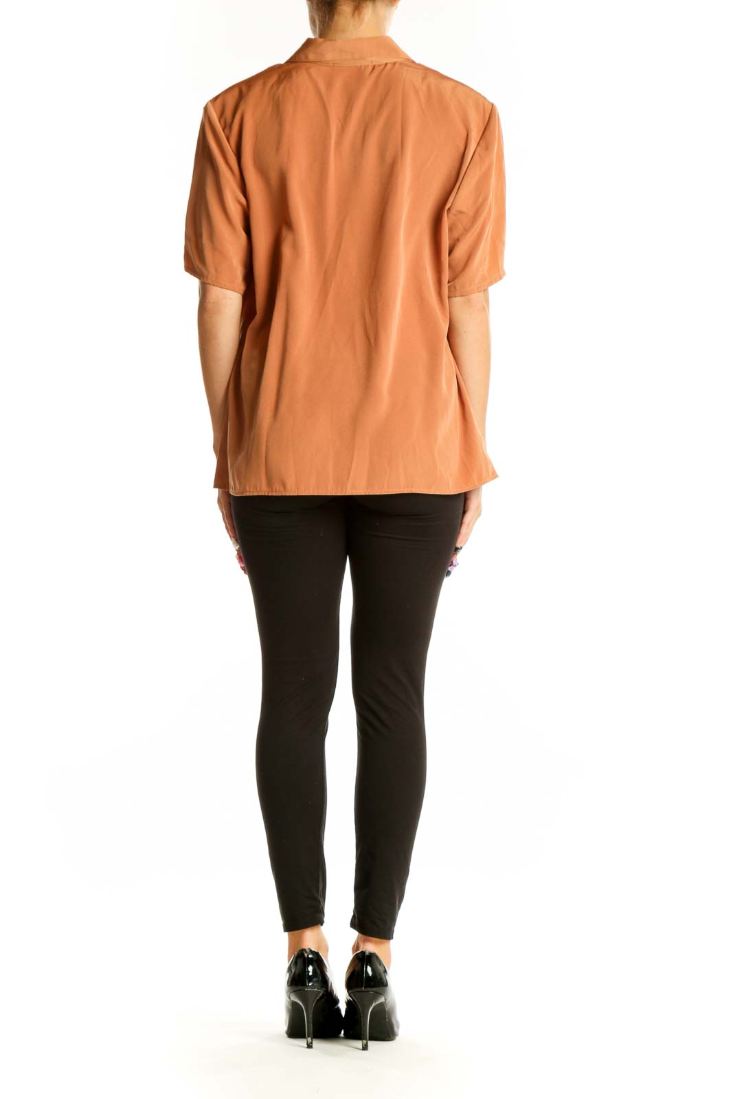 Side view of model wearing Maggie Sweet terracotta button-up blouse with black pants