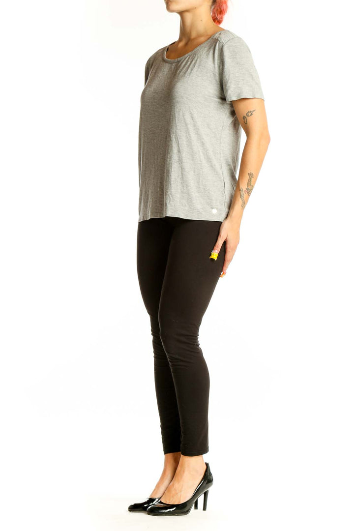 Front view of gray Juicy Couture short sleeve top on model