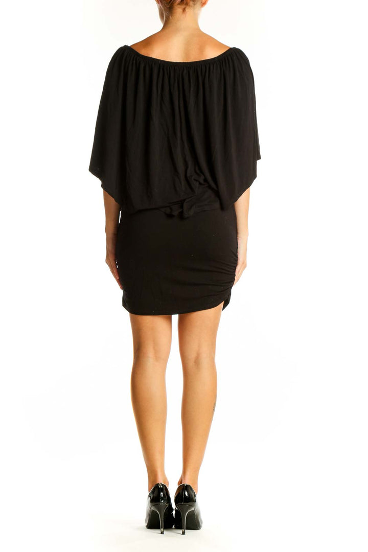 Side view of black off-shoulder mini dress with draped overlay from Boston Proper