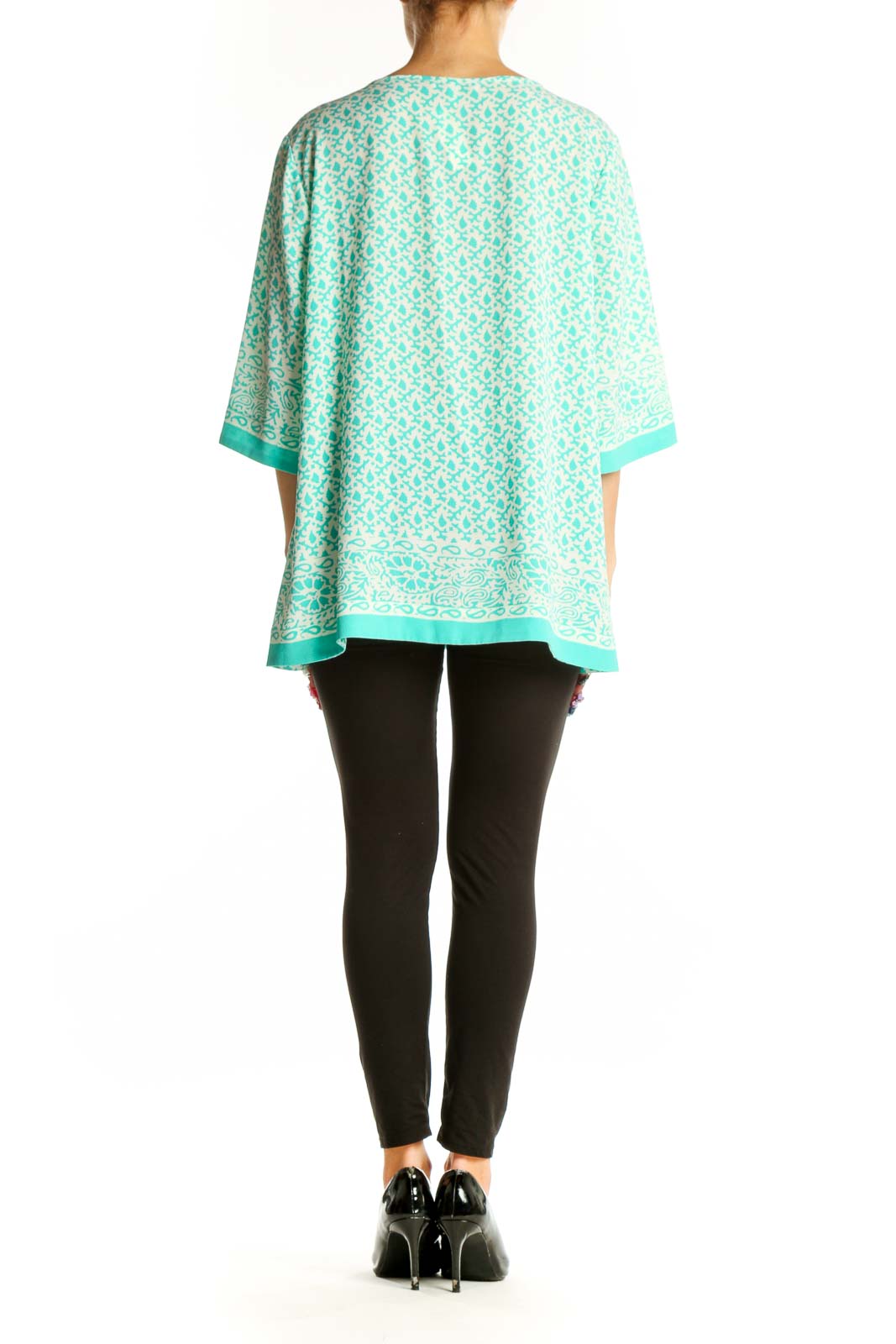 Side view of model wearing Chaus mint floral print tunic top with black pants