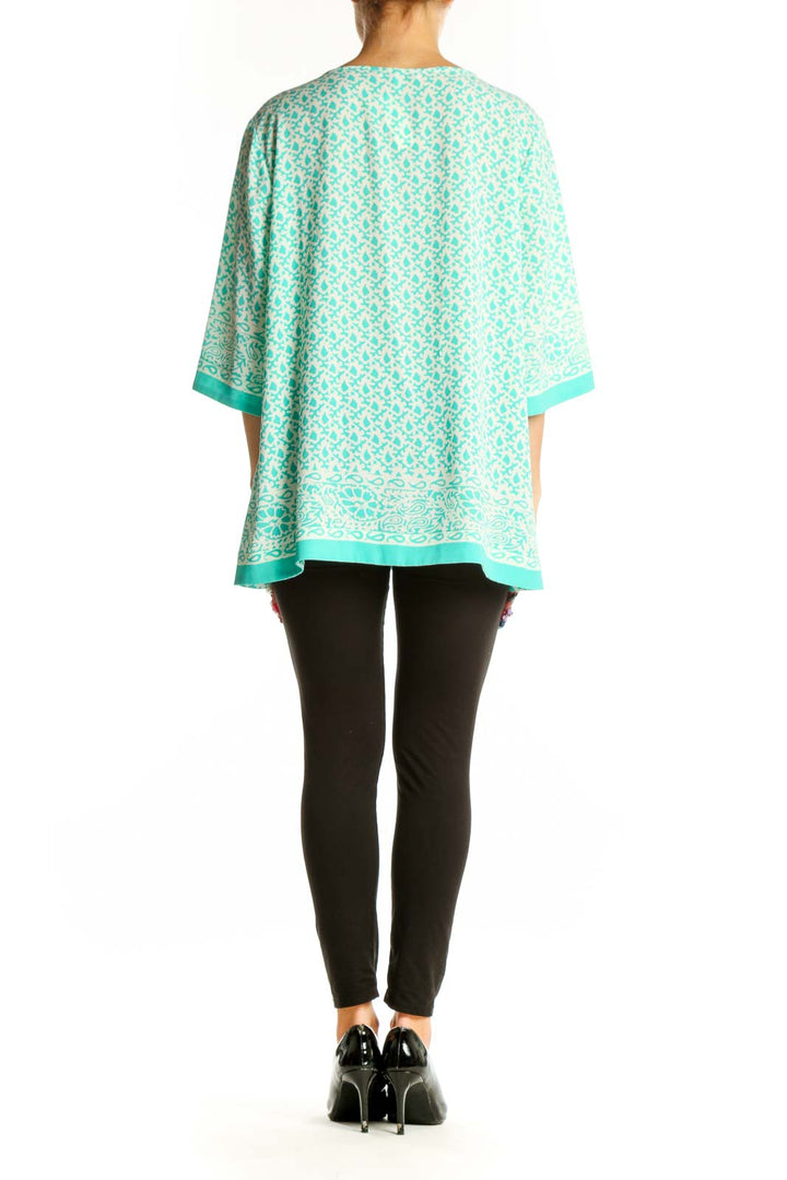 Side view of model wearing Chaus mint floral print tunic top with black pants