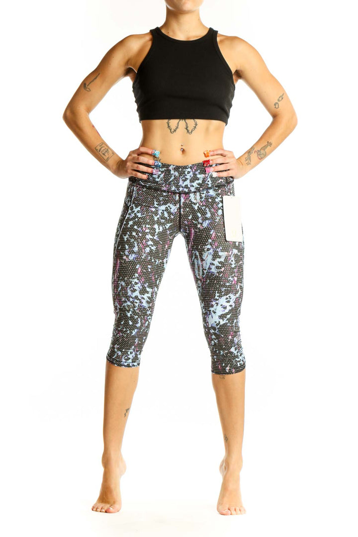 Front view of Lululemon blue floral print capri leggings on model