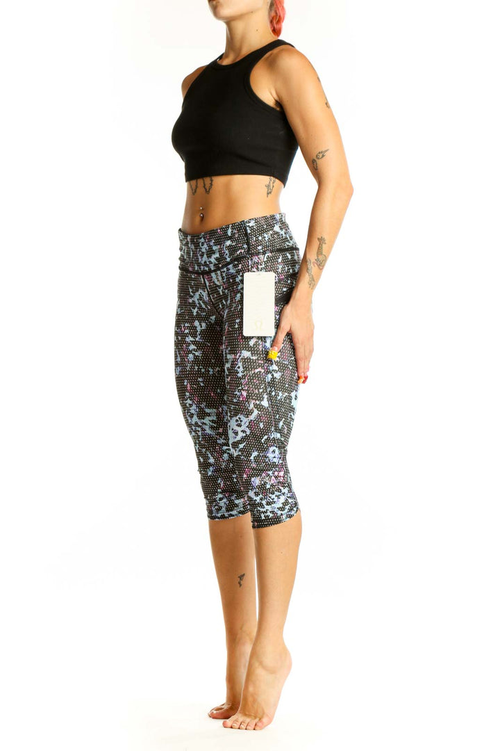 Front view of Lululemon blue floral print capri leggings on model