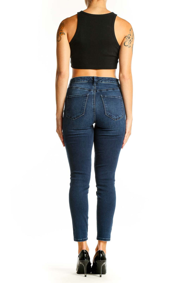 Side view of Talbots dark blue skinny jeans on model with black crop top