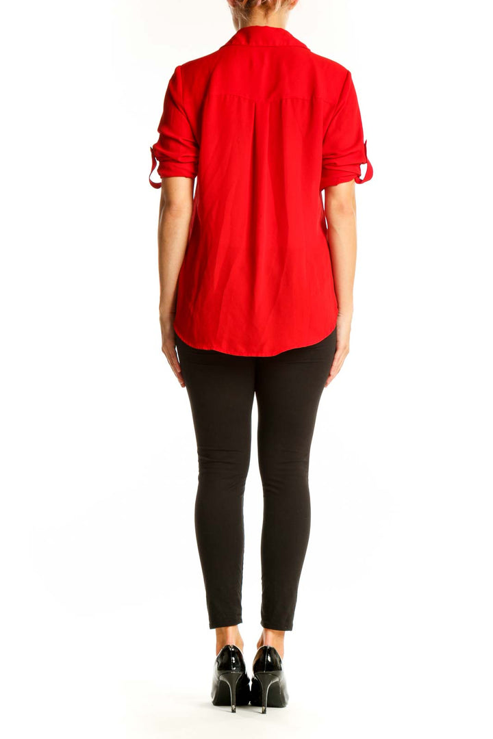 Side view of red Express polyester button-down blouse on model