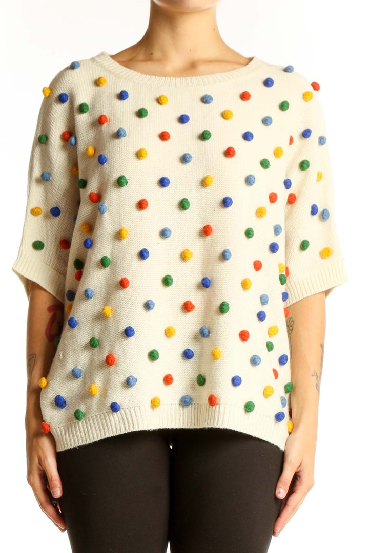 Front view of cream PepaLoves knit sweater with multicolored polka dots