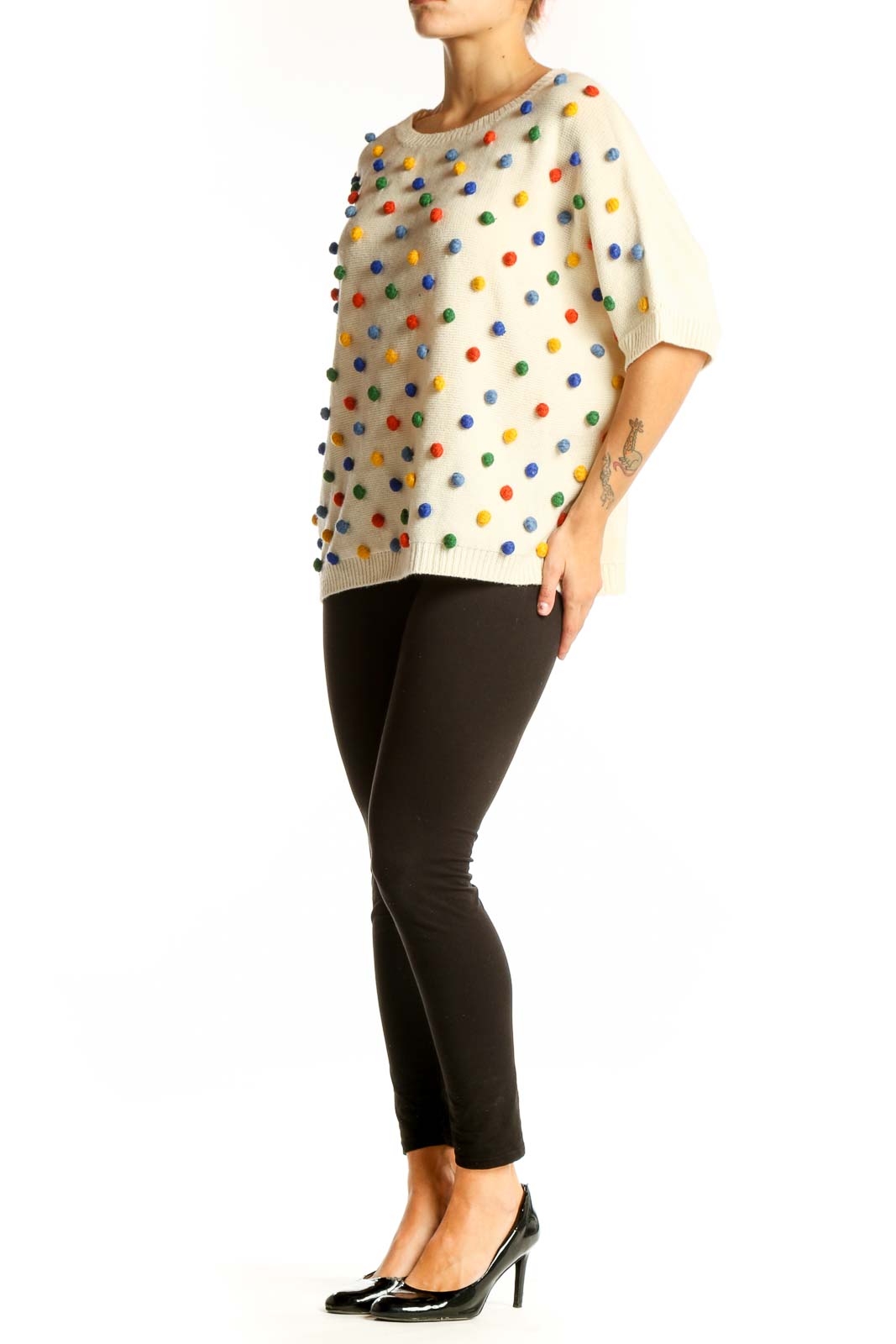 Front view of cream PepaLoves knit sweater with multicolored polka dots