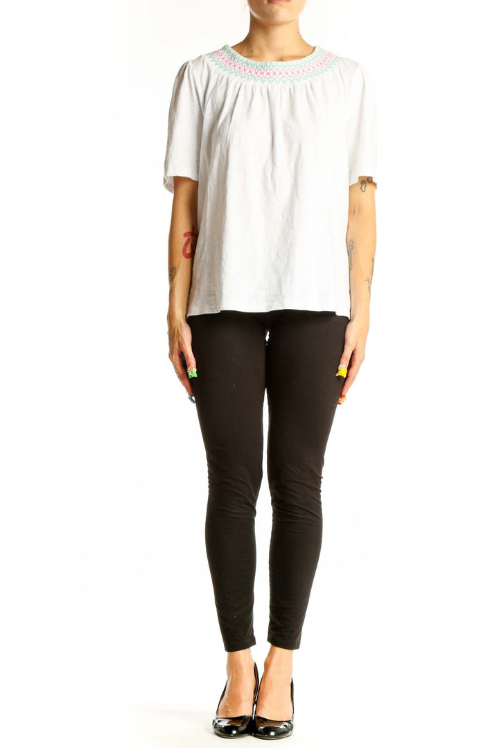 Front view of white Boden cotton top with embroidered neckline