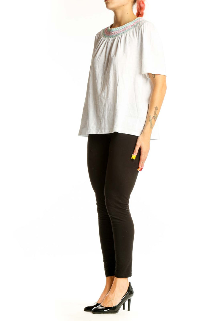 Front view of white Boden cotton top with embroidered neckline