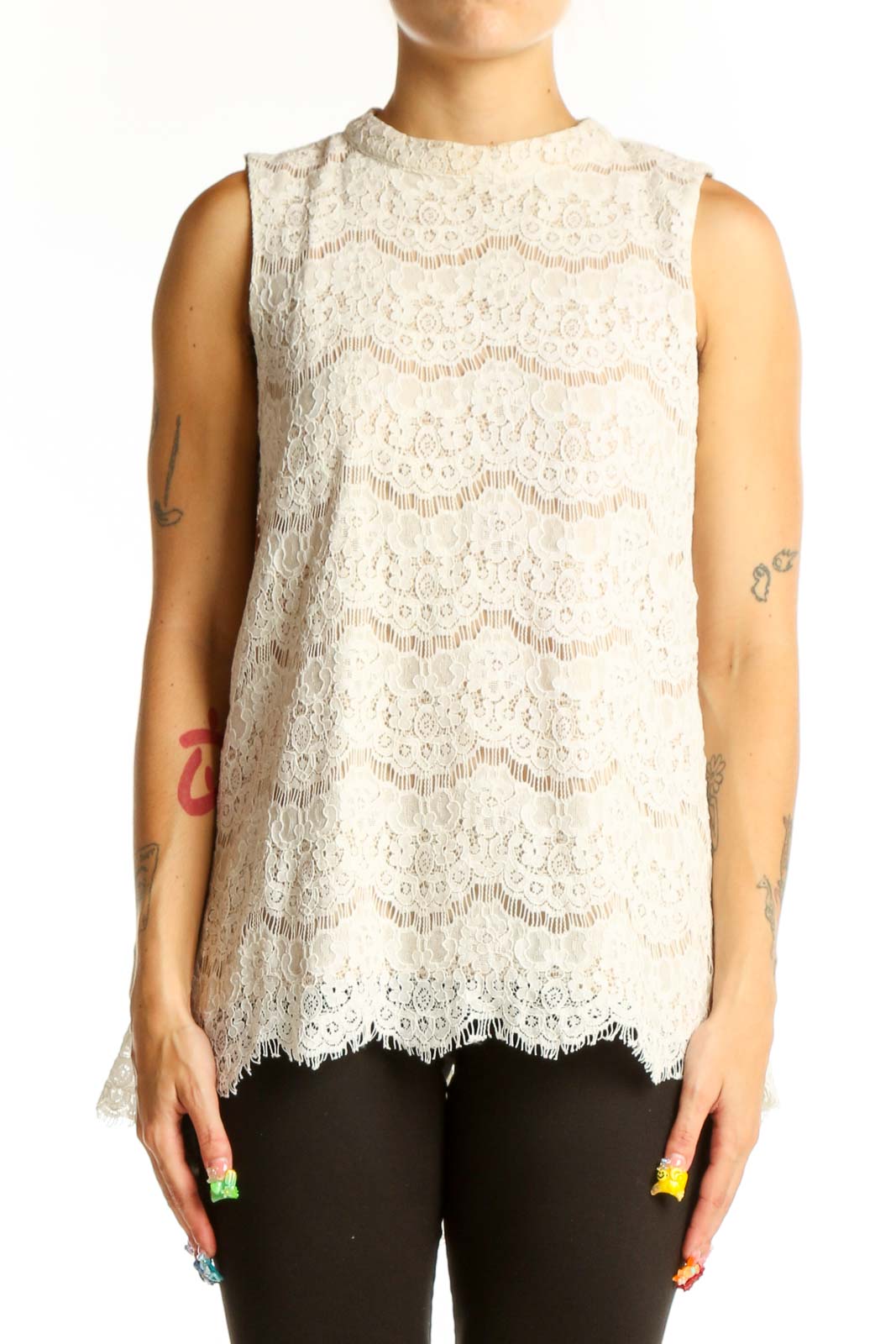 Front view of white lace sleeveless blouse with floral pattern