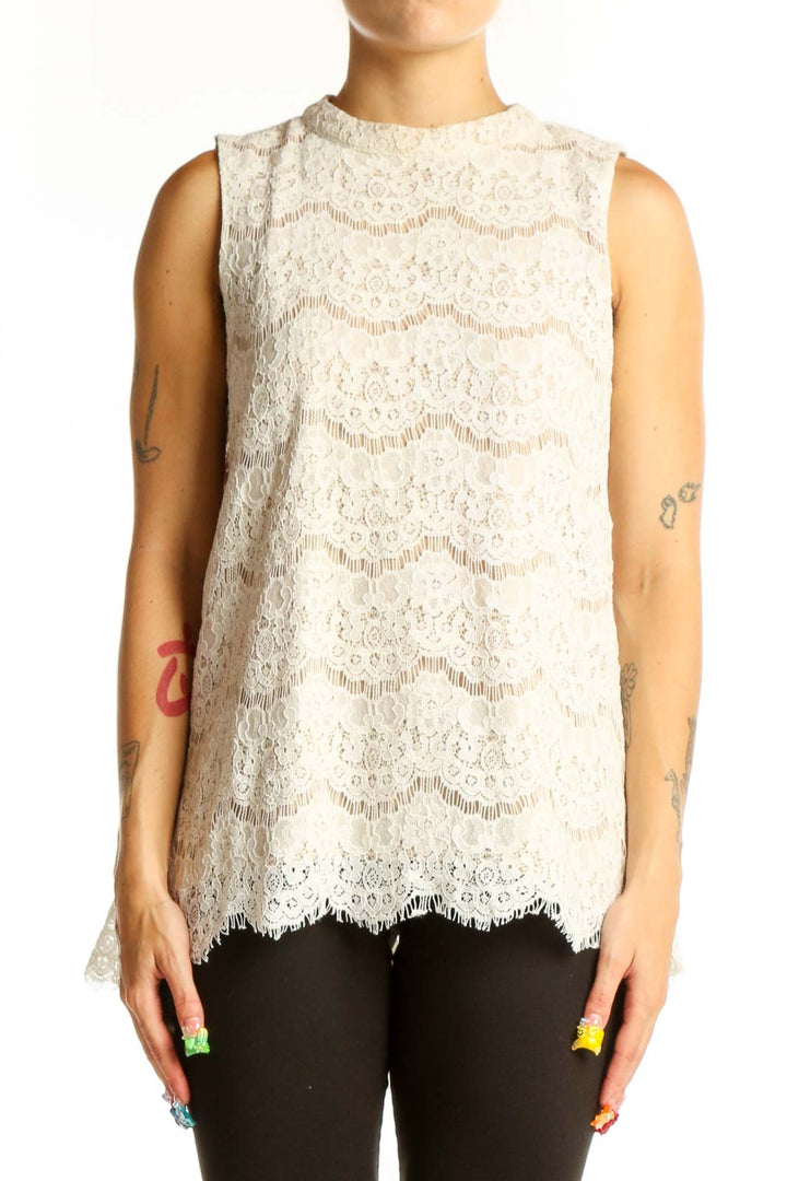 Front view of white lace sleeveless blouse with floral pattern