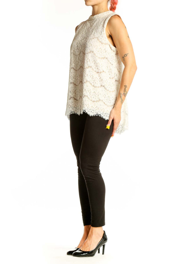Front view of white lace sleeveless blouse with floral pattern