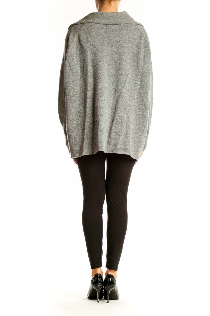 Side view of woman wearing gray oversized zip-up knit cardigan by Ellen Tracy