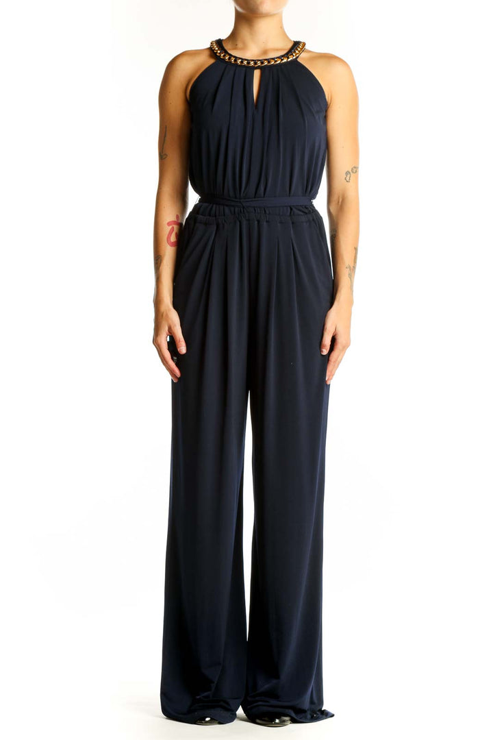 Front view of Vince Camuto navy jumpsuit with gold chain halter neck