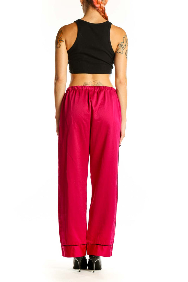 Side view of red Oscar de la Renta PINK LABEL lounge pants on model