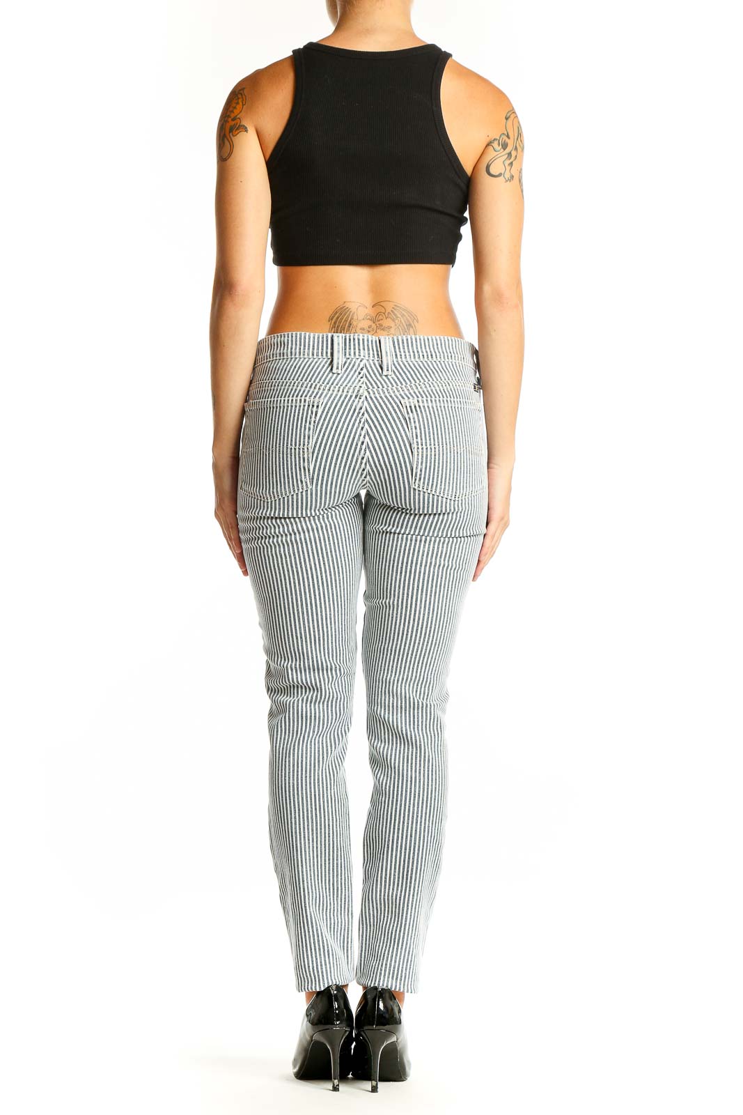 Side view of woman wearing Lucky Brand blue striped slim fit pants with black top