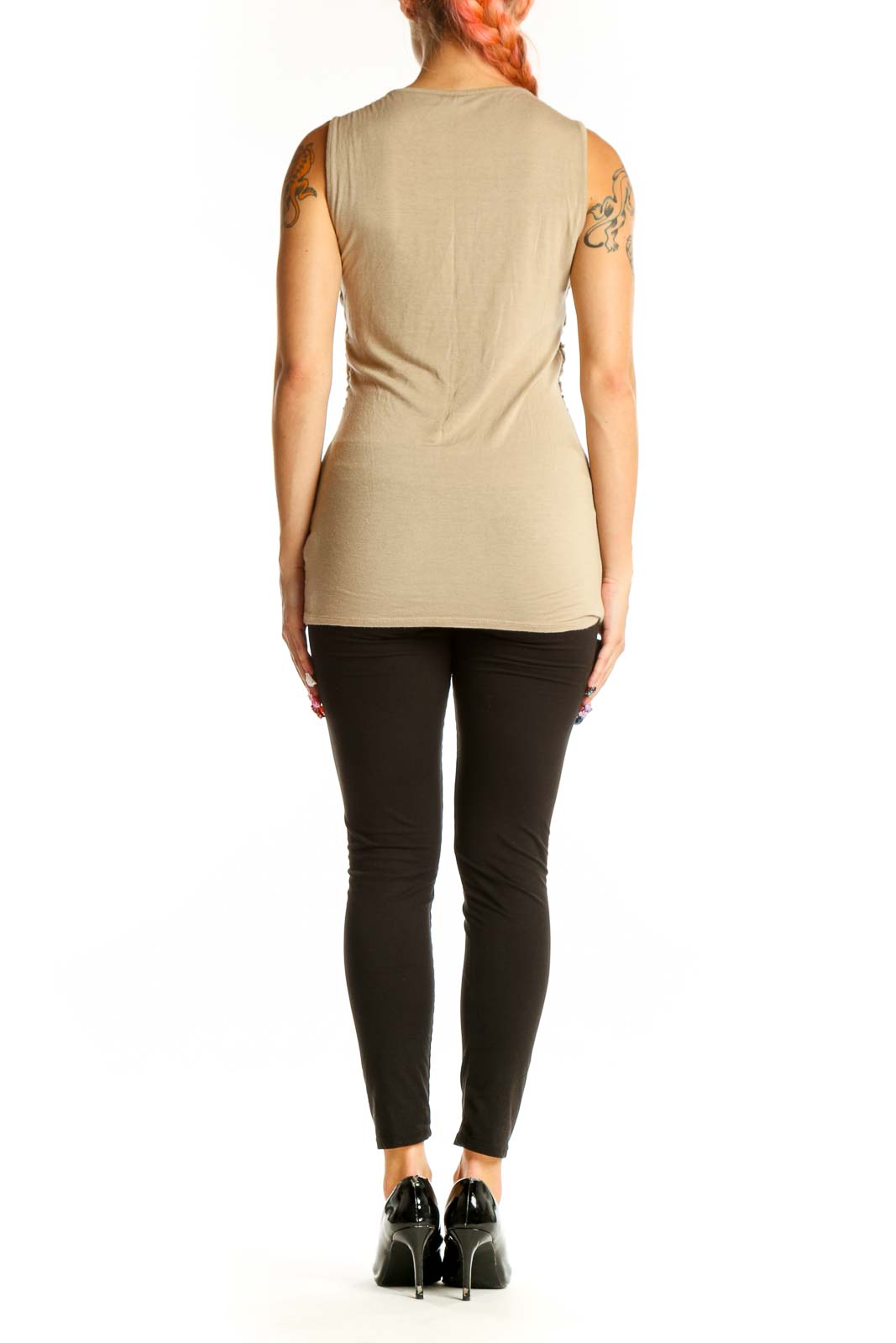 Side view of model wearing beige ruched sleeveless top from Maurices with black pants