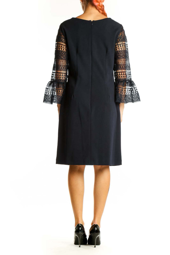 Side view of Donna Ricco black cocktail dress showing lace sleeve detail