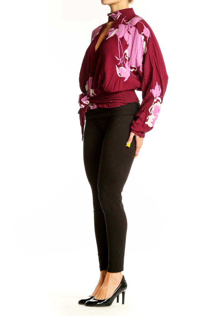 Front view of burgundy floral print wrap top with V-neckline and choker collar
