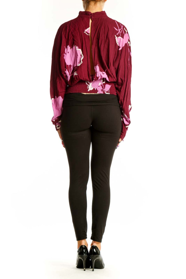 Side view of burgundy floral print wrap top showing long sleeves and wrap design