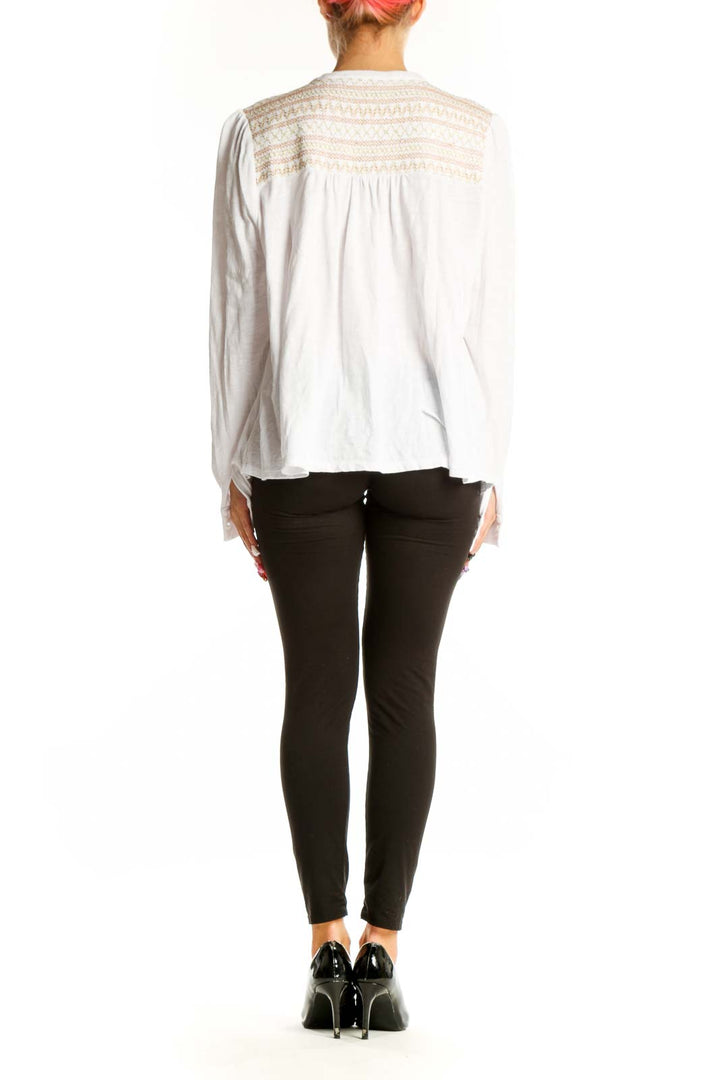 Side view of white Boden cotton top showing long sleeves and relaxed fit