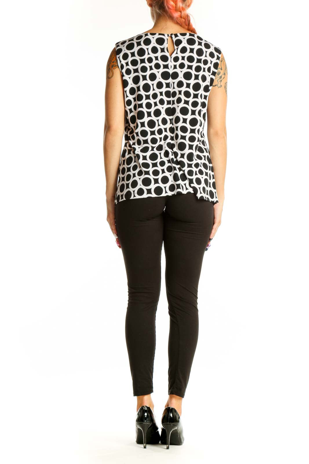 Side view of Calvin Klein Black and White Polka Dot Sleeveless Top on model