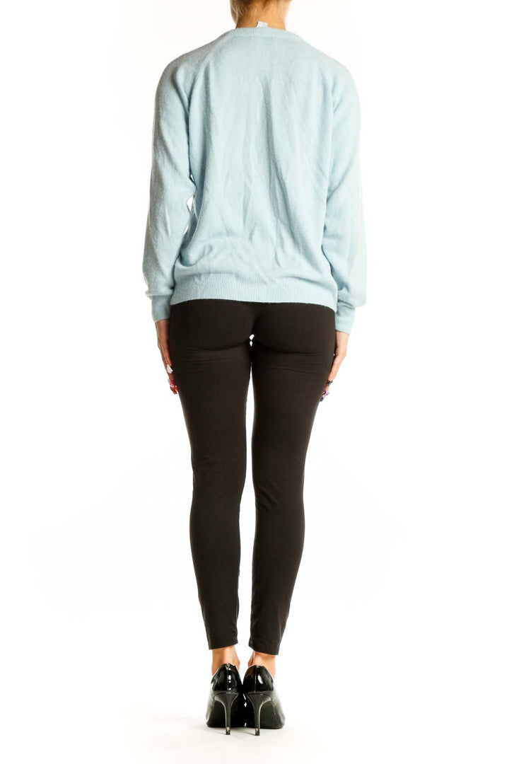 Side view of light blue acrylic button-up cardigan by Designers Originals on model
