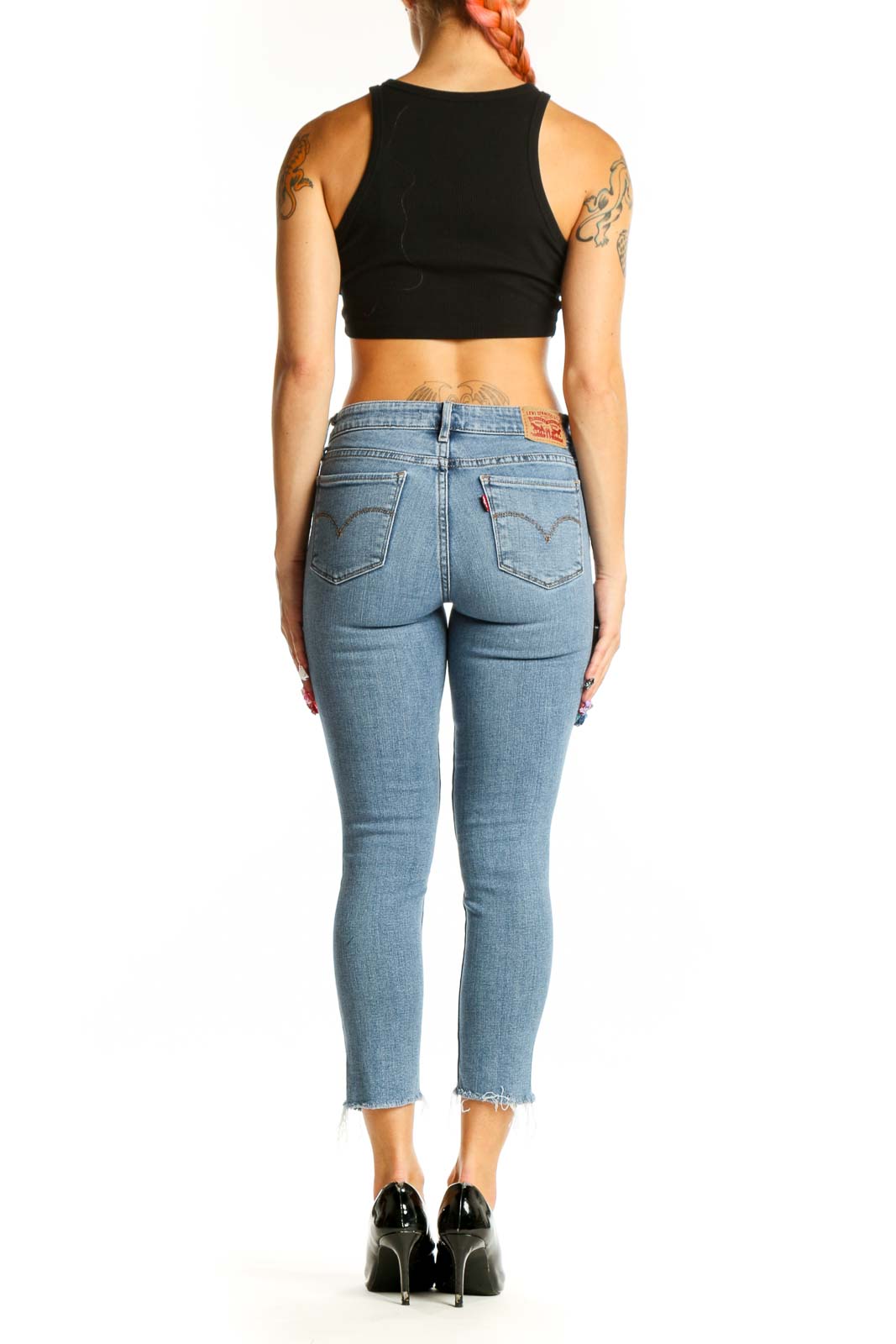 Side view of woman wearing 711 Levis light blue distressed cropped skinny jeans