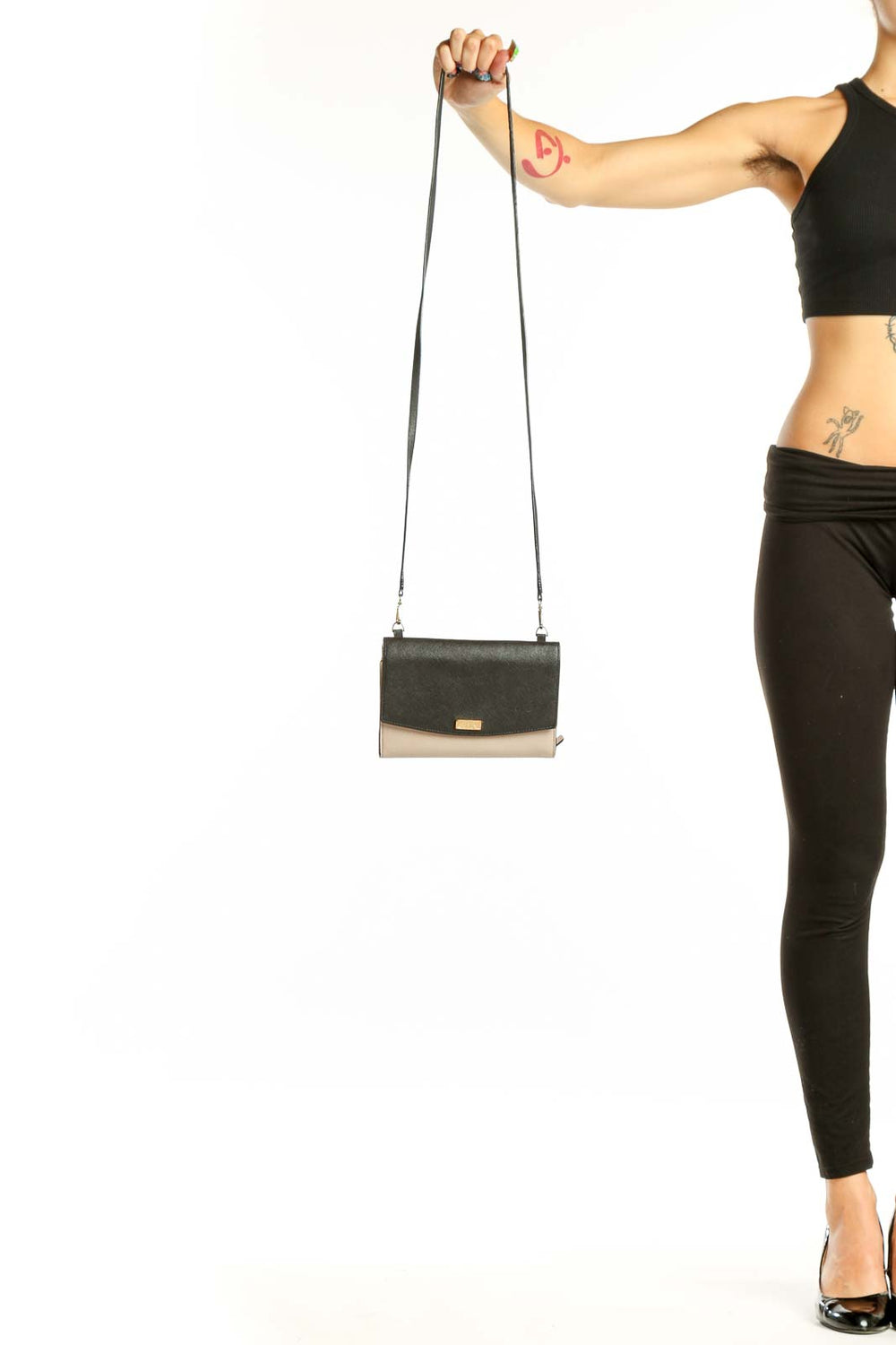 Front view of Kate Spade black and beige colorblock crossbody bag
