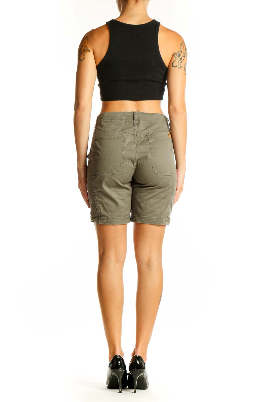 Side view of olive green Tentree 10 chino shorts on model with black crop top