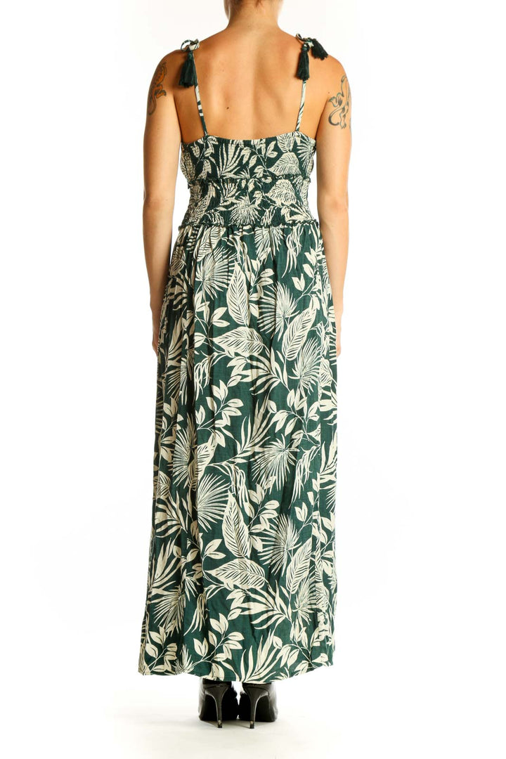 Side view of green tropical print maxi dress showing side slit and full length