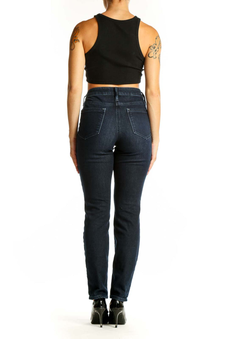 Back view of Athleta dark blue slim fit denim jeans on model