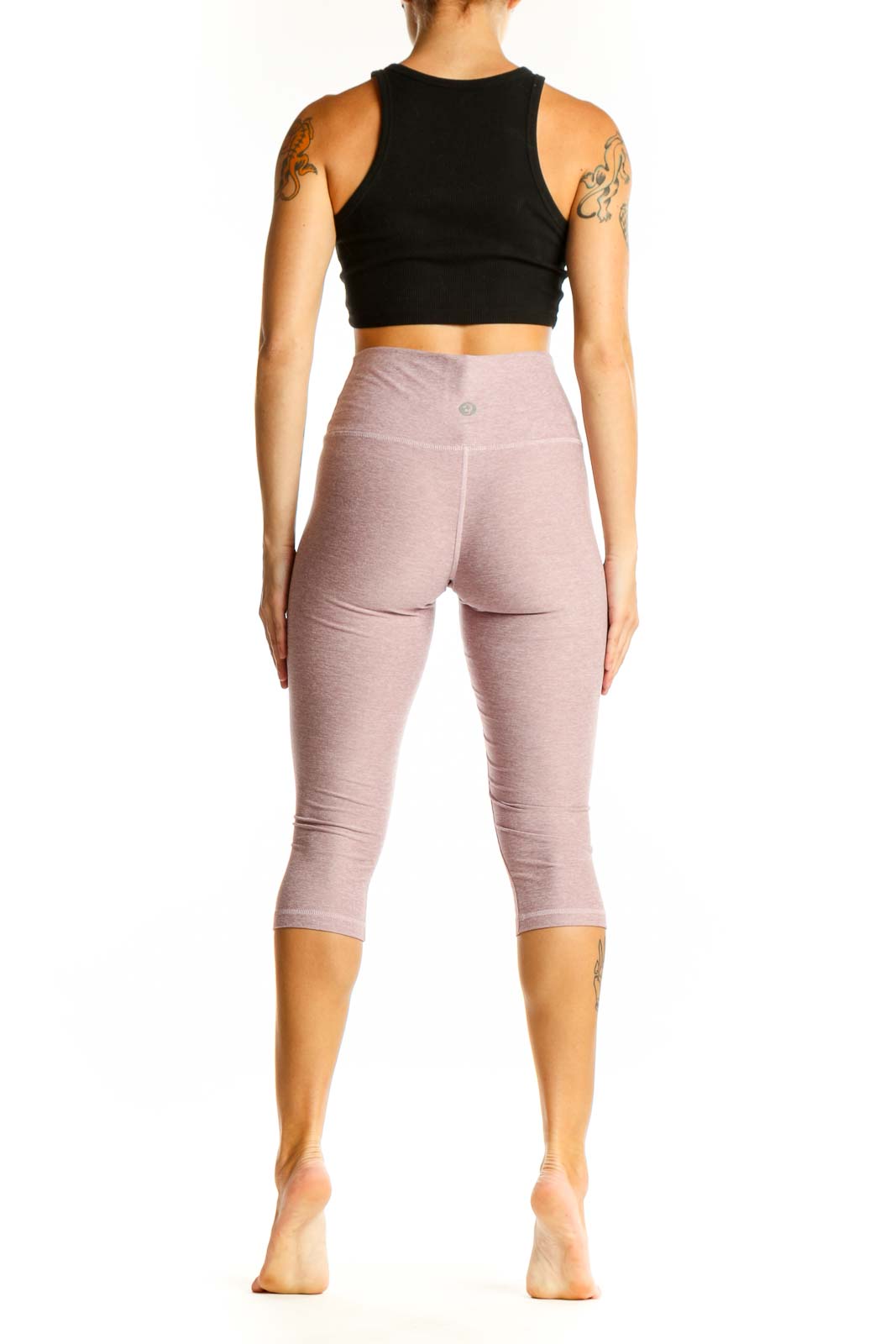 Side view of woman wearing Scorpio Sol dusty rose capri leggings with black crop top