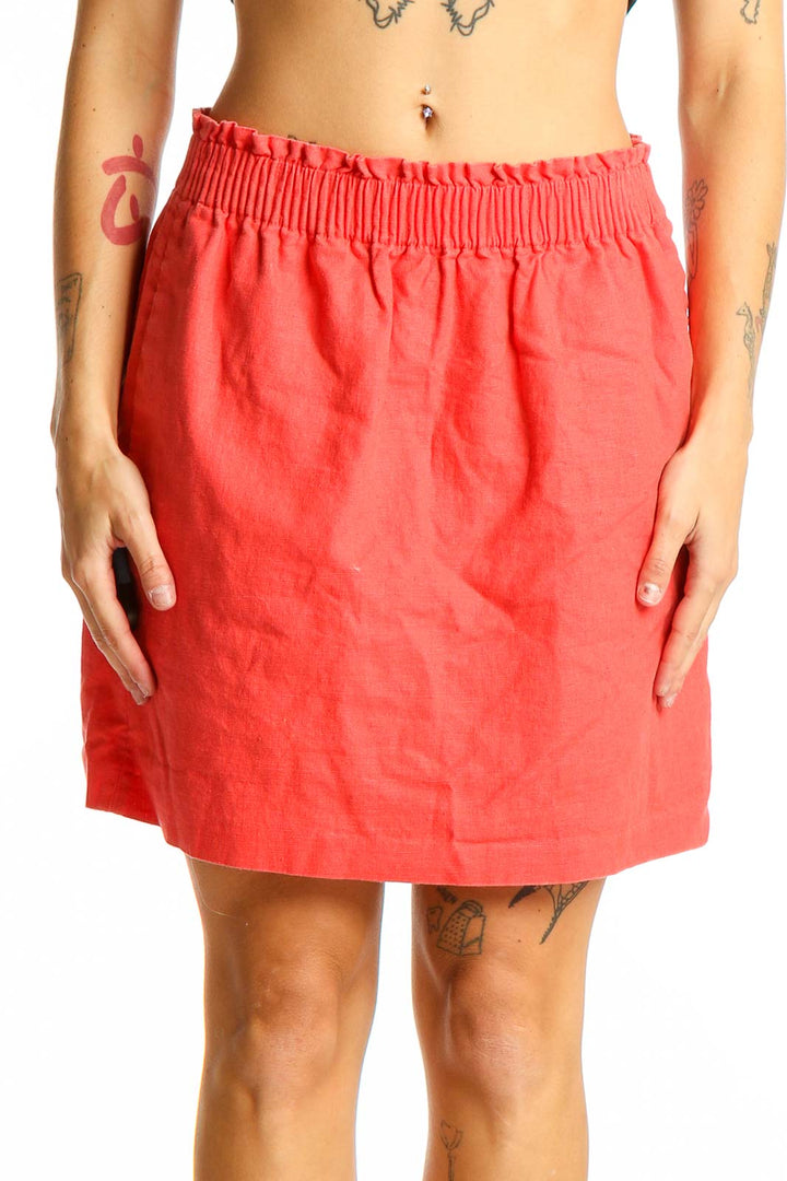 Front view of coral J.Crew mini skirt with elastic waistband