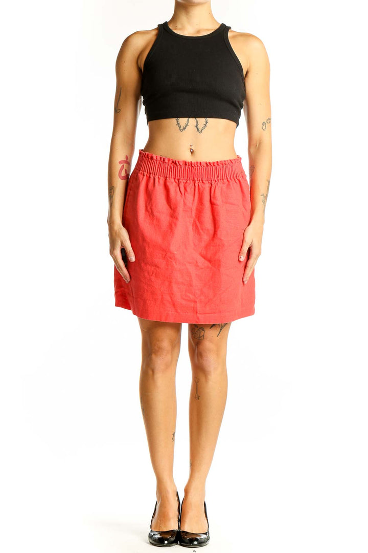 Front view of coral J.Crew mini skirt with elastic waistband