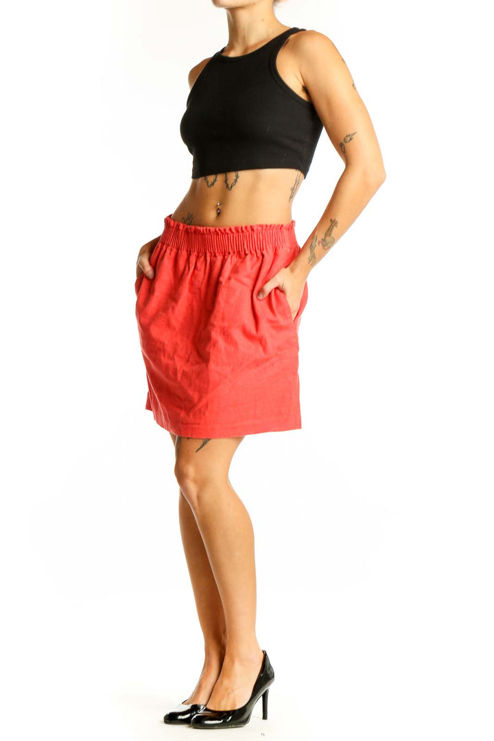 Front view of coral J.Crew mini skirt with elastic waistband