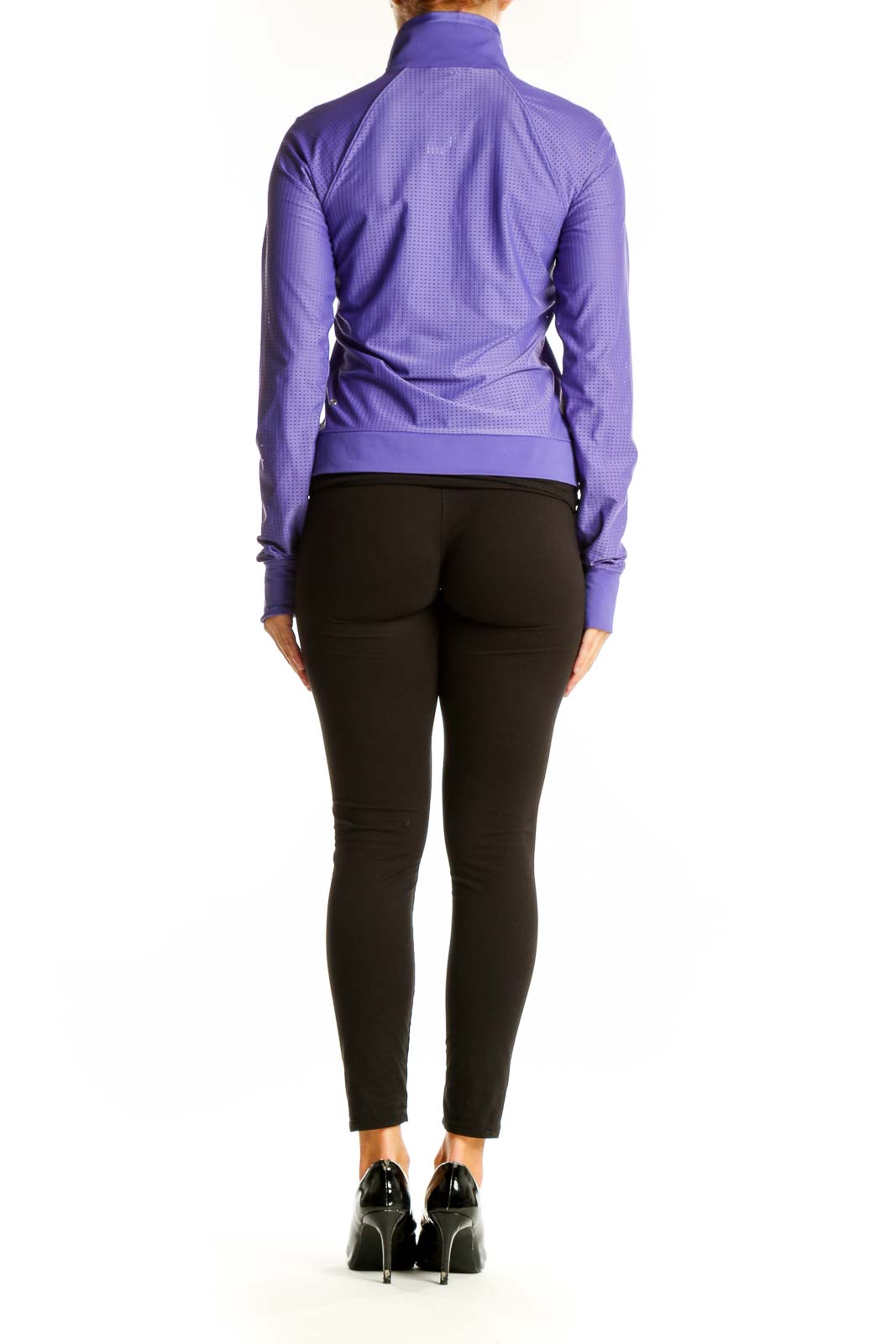 Side view of woman wearing purple Lululemon athletic jacket with black pants