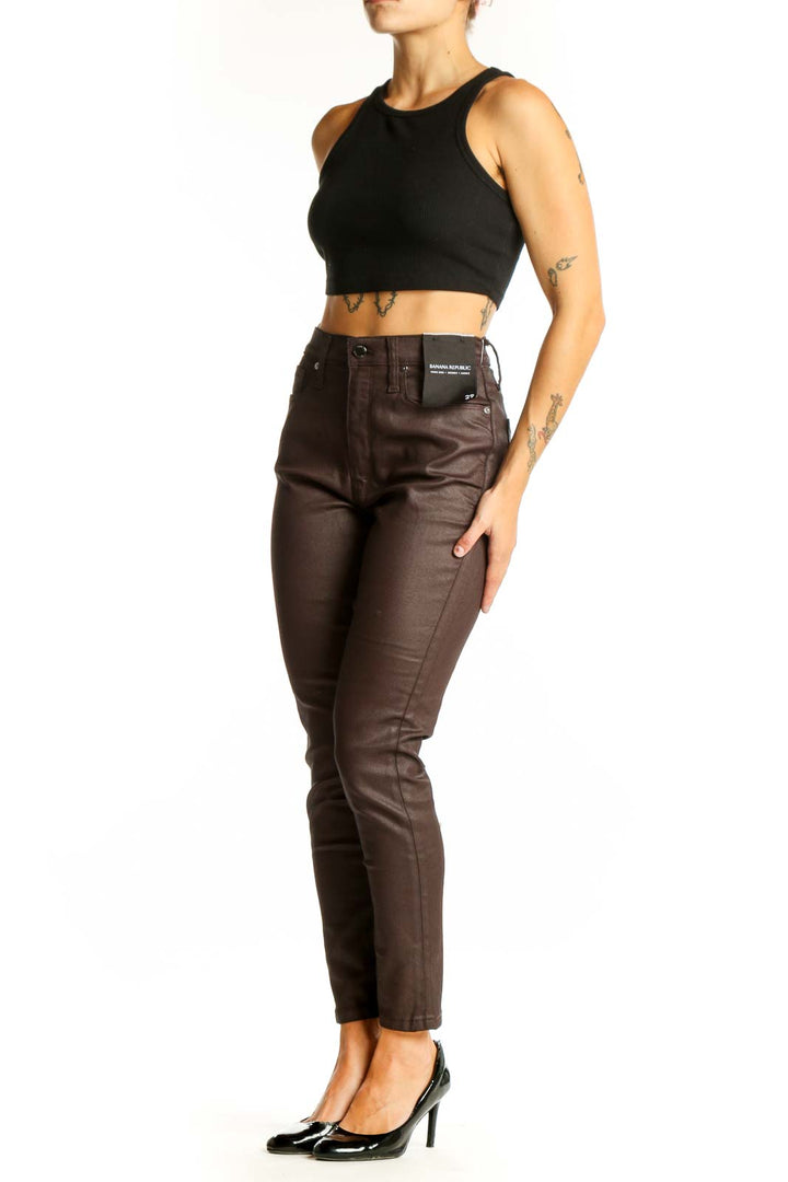 Front view of Banana Republic brown coated skinny jeans on model