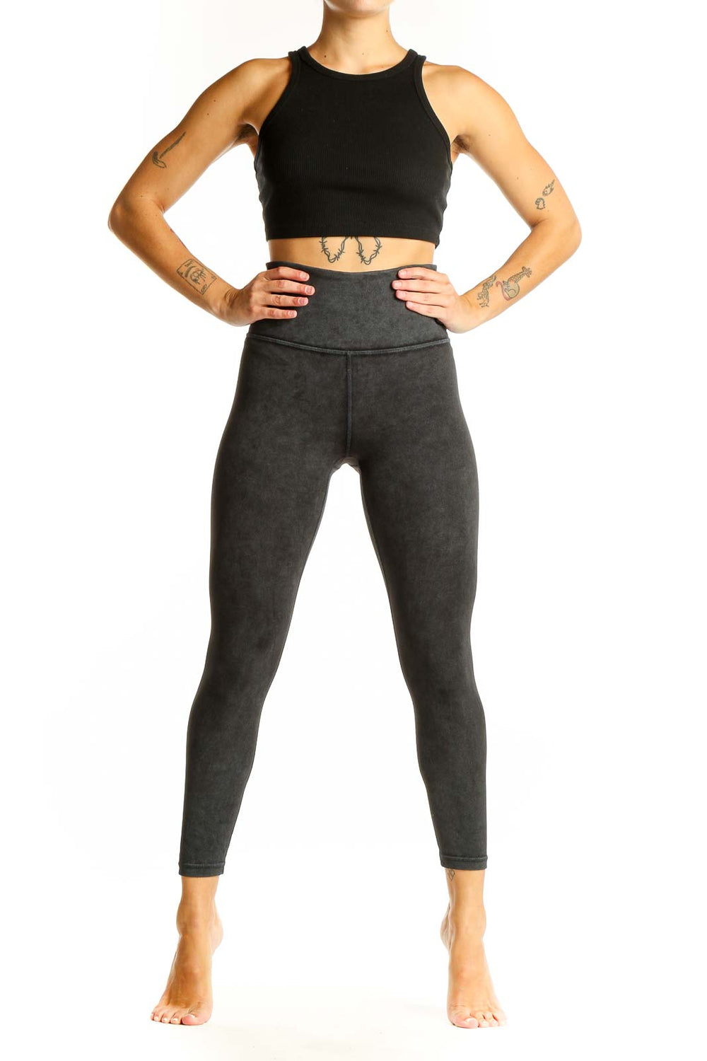 Front view of Athleta black crop top and charcoal gray high-waisted leggings activewear set