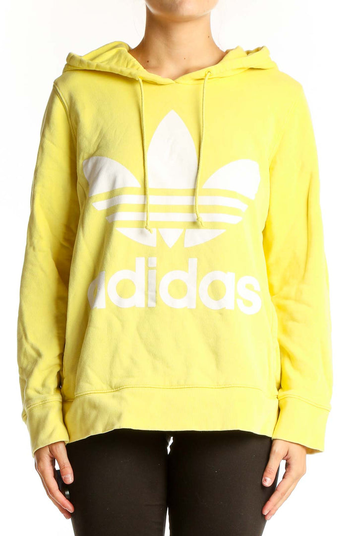 Front view of yellow Adidas hoodie with white Trefoil logo