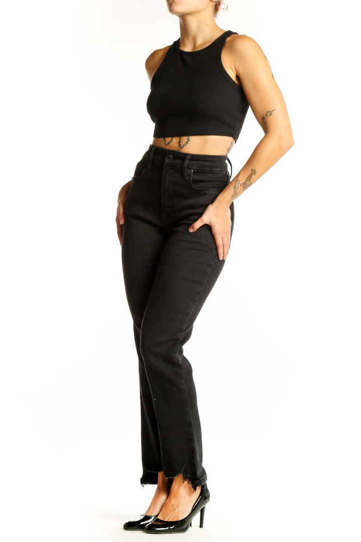 Front view of Good American black high-waisted straight-leg jeans with raw hem